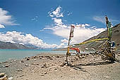 Ladakh - pile of stones on  mountain pass with the characteristc prayer flags